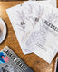 90 Days Guided Journals on a table with a macbook pro laptop